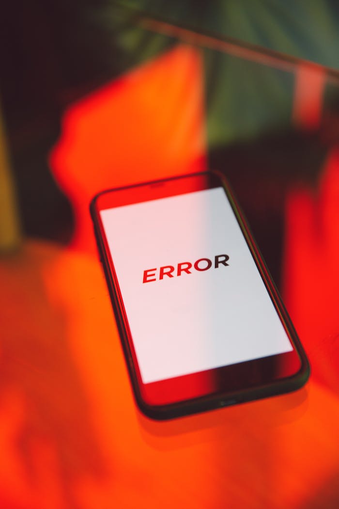 A close-up view of a smartphone showing an error message against a vibrant red background, symbolizing tech issues.